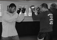 Scott Rehm training a student in boxing