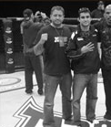 Tim Burrill and Matt Phinney standing on the Tapout banner